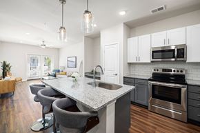 Surf City apartment for rent - an open kitchen and living room with a marble counter top