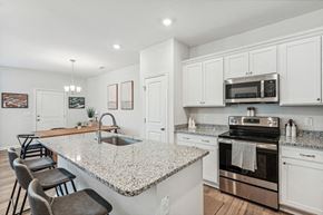 Raleigh townhouse for rent - a kitchen with a marble counter top and a sink