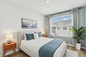 Raleigh townhouse for rent - a bedroom with a bed and a large window