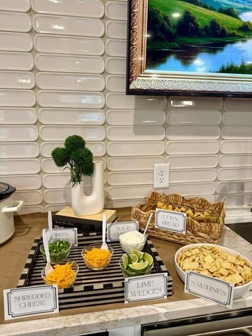 Knightdale townhouse for rent - A buffet table with a variety of foods including shredded cheese, lime wedges, and saltines.