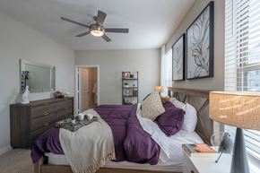 New Market apartment for rent - bedroom with bed and ceiling fan and dresser with a mirror