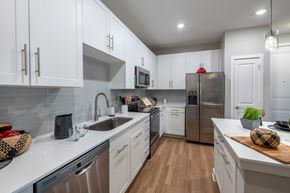 New Market apartment for rent - a kitchen with white cabinets and stainless steel appliances