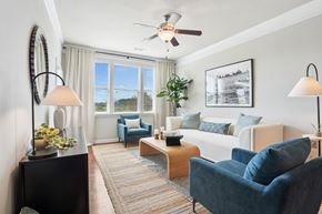 Mooresville apartment for rent - A living room with a white couch, blue chairs, and a coffee table.