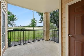 Mansfield apartment for rent - A view from a patio looking out to a green lawn and trees.