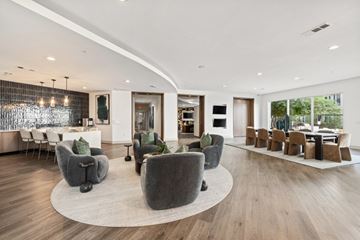 Dallas apartment for rent - A modern living room with grey chairs and a wooden floor.