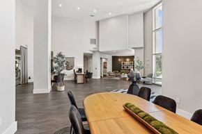 Dallas apartment for rent - A modern dining room with a long wooden table and black chairs.