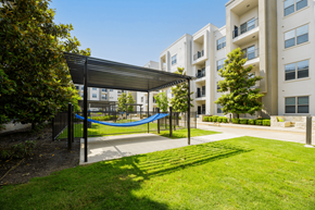 Dallas apartment for rent - A playground with a blue rope is surrounded by apartment buildings.