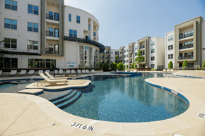 Dallas apartment for rent - A swimming pool in front of apartment buildings.