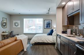 Raleigh apartment for rent - a bedroom with a bed and a kitchen with a sink