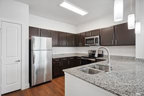 Garland apartment for rent - a kitchen with granite counter tops and stainless steel appliances