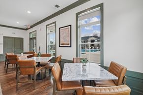Wake Forest apartment for rent - White and grey tables with brown chairs