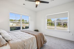 Wake Forest apartment for rent - a bedroom with a bed and two windows