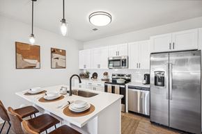 Wake Forest apartment for rent - B2A model unit a kitchen with stainless steel appliances and a white counter top
