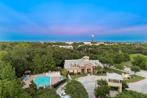 Denton apartment for rent - A large building with a pool in front of it.