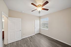 Denton apartment for rent - an empty bedroom with a ceiling fan and a window