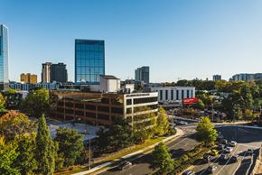 Atlanta apartment for rent - an aerial view of a city with a building and a parking lot