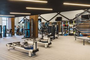 Atlanta apartment for rent - a gym with weights and cardio equipment and a staircase
