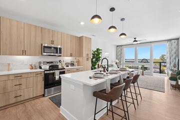Wilmington apartment for rent - A modern kitchen with a dining table set for four.