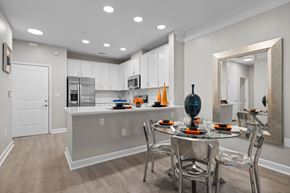 Johns Creek apartment for rent - A modern kitchen with a dining table set for two.