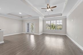 Johns Creek apartment for rent - A spacious room with a ceiling fan and sliding glass doors leading to a balcony.
