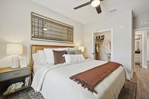 Greensboro apartment for rent - A bedroom with a large bed and a ceiling fan.