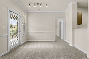 Rockwall apartment for rent - A spacious room with a carpeted floor and white walls.
