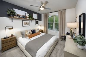 Suwanee apartment for rent - bedroom model with large bed and ceiling fan