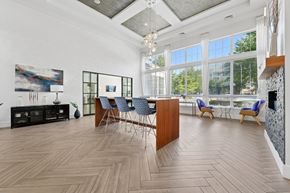 Ashburn apartment for rent - A spacious room with wooden flooring and a large window.