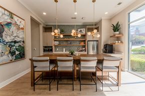 Raleigh apartment for rent - A modern dining room with a wooden table and chairs.