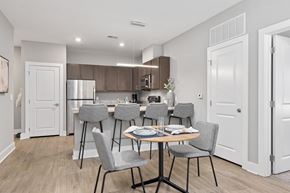 Raleigh apartment for rent - A kitchen with a table and chairs in the middle of the room.