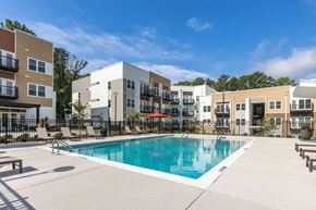 Raleigh apartment for rent - A swimming pool in front of apartment buildings.