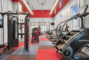 Spartanburg apartment for rent - a gym with treadmills and other exercise equipment on a red floor