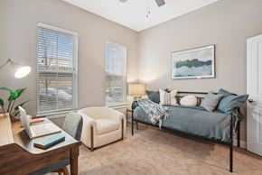 Spartanburg apartment for rent - a bedroom with a bed and a desk with a laptop
