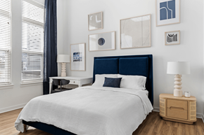 Wilmington apartment for rent - A bedroom with a large bed and a wooden nightstand.