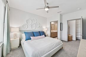 Vero Beach apartment for rent - A bedroom with a large bed and a ceiling fan.