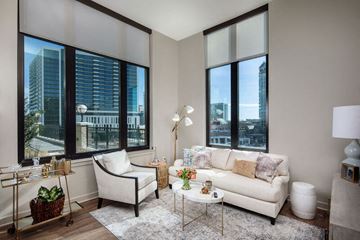 Atlanta apartment for rent - a living room with a white couch and large windows