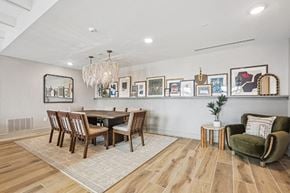 Charlotte apartment for rent - A wooden table and chairs around it with picture frames on the wall.