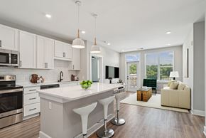 Charlotte apartment for rent - A modern kitchen with white cabinets and a large island.