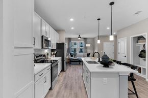 Wilmington apartment for rent - A modern kitchen with white cabinets and a large island.