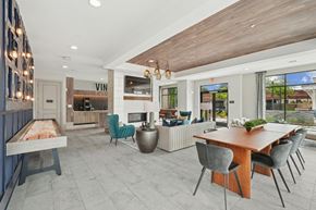 Durham apartment for rent - A modern room with a pool table, seating area, and a bar area.