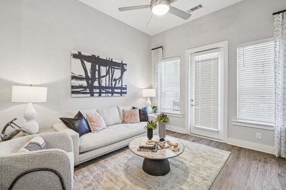 Durham apartment for rent - A living room with a grey couch, a coffee table, and a painting on the wall.