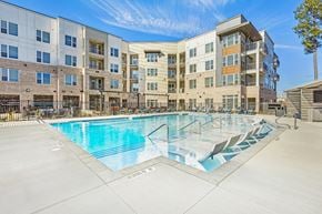 Durham apartment for rent - A large swimming pool in front of apartment buildings.