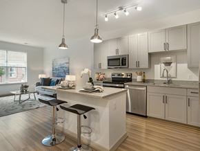 Woodbridge apartment for rent - A modern kitchen with a bar stool in front of the island.
