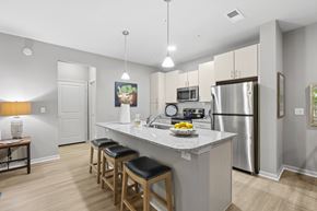 Clearwater apartment for rent - A kitchen with a refrigerator, microwave, and stove top oven.