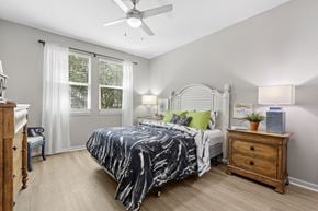 Clearwater apartment for rent - A bedroom with a bed, nightstand, and window.