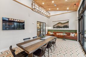 Pittsboro apartment for rent - a dining area with a wooden table and chairs and a living room with a couch