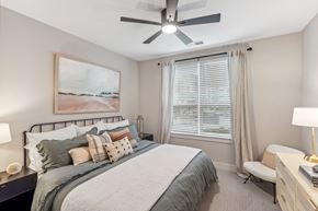 Pittsboro apartment for rent - a bedroom with a large bed and a ceiling fan