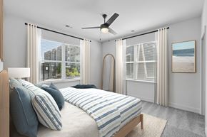 Knightdale townhouse for rent - A bedroom with a large bed and a view of the beach.