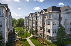 Roseland triplex for rent - A row of white apartment buildings with green lawns and trees in front.