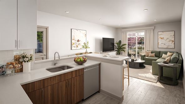 Roseland triplex for rent - A modern kitchen with a wooden island and a green sofa in the living room.